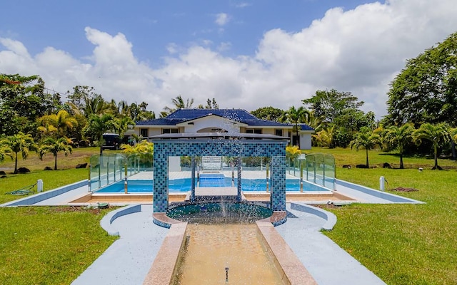 view of pool with a lawn