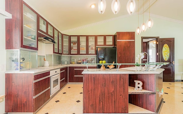 kitchen featuring an island with sink, vaulted ceiling, pendant lighting, and black appliances