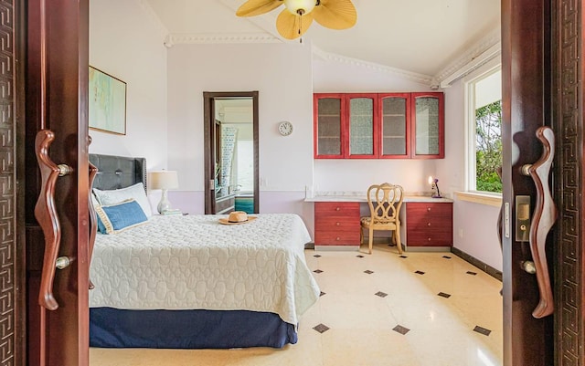 bedroom featuring built in desk, vaulted ceiling, and ceiling fan