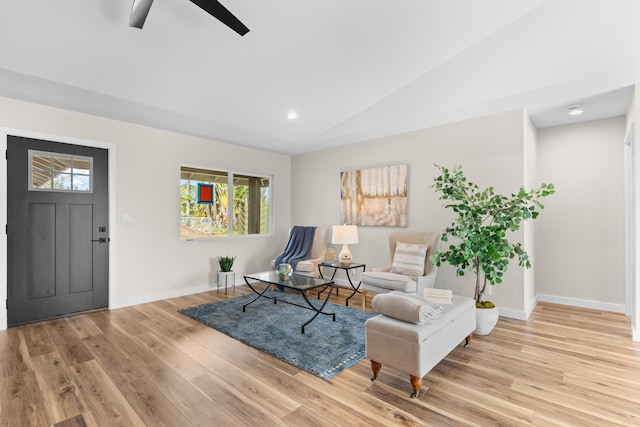 living area featuring ceiling fan, vaulted ceiling, and light hardwood / wood-style flooring