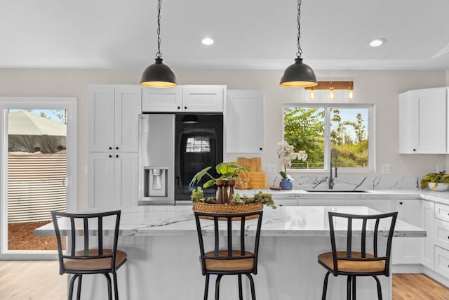 kitchen featuring white cabinetry, sink, and a kitchen bar