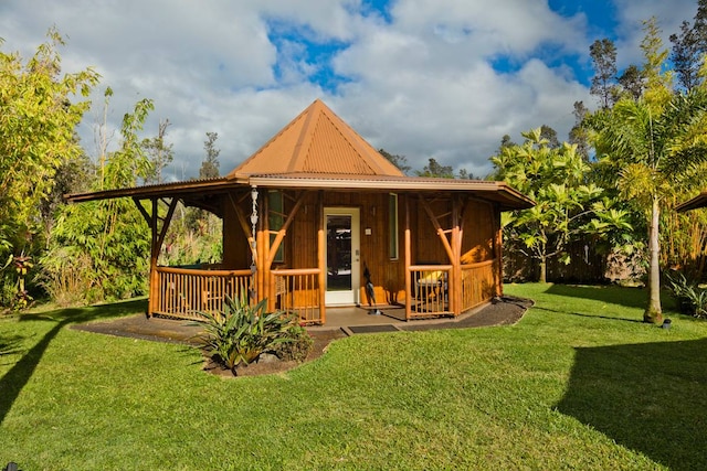 rear view of property with a lawn