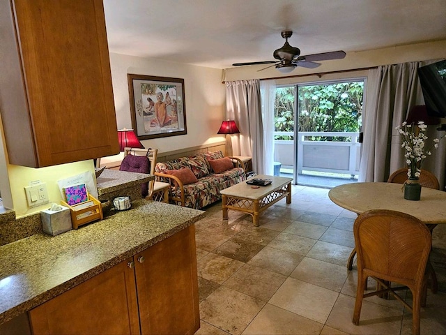 living room featuring ceiling fan and tile patterned flooring