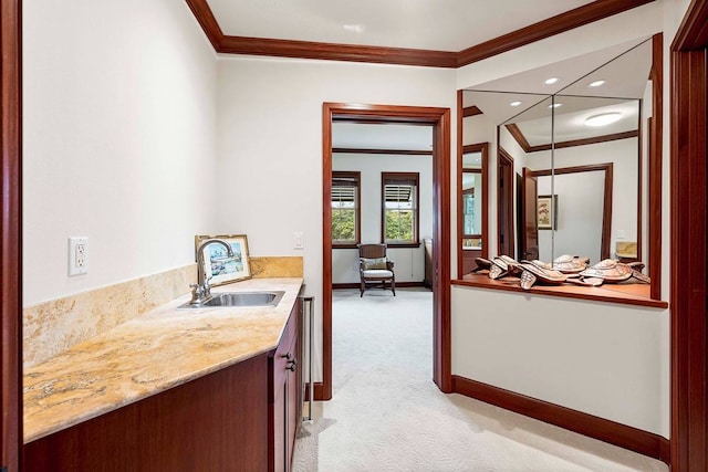 interior space featuring sink, light carpet, crown molding, and light stone countertops