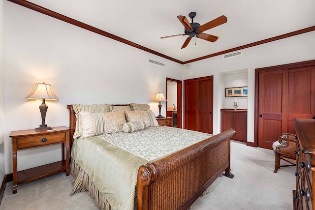 carpeted bedroom with ceiling fan and ornamental molding