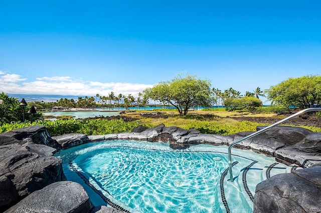 view of swimming pool with a water view