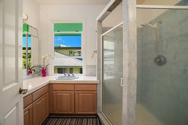 bathroom with vanity and a shower with shower door