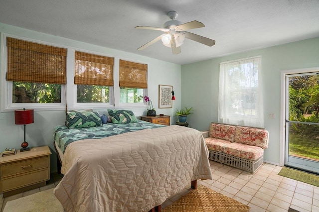 tiled bedroom featuring ceiling fan and multiple windows