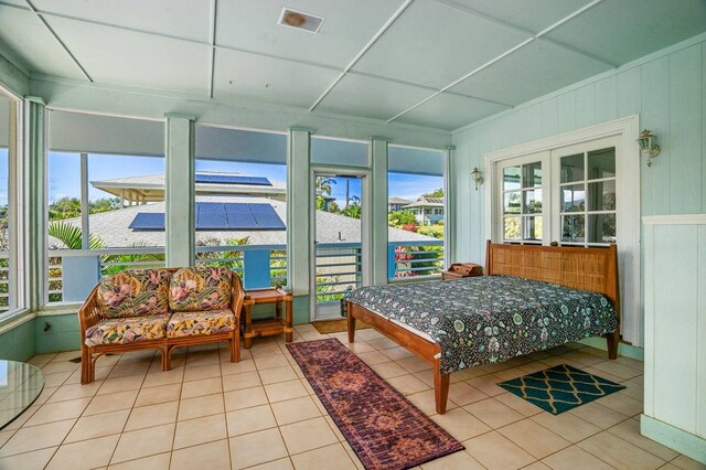 bedroom featuring french doors and light tile floors