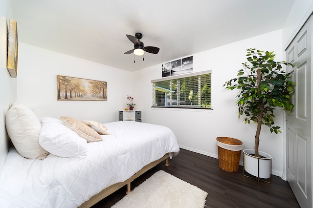 bedroom with ceiling fan, a closet, and dark hardwood / wood-style floors