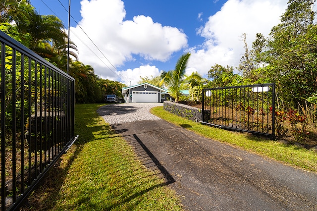 view of gate with a lawn