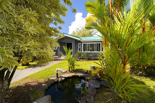 rear view of property with a lawn