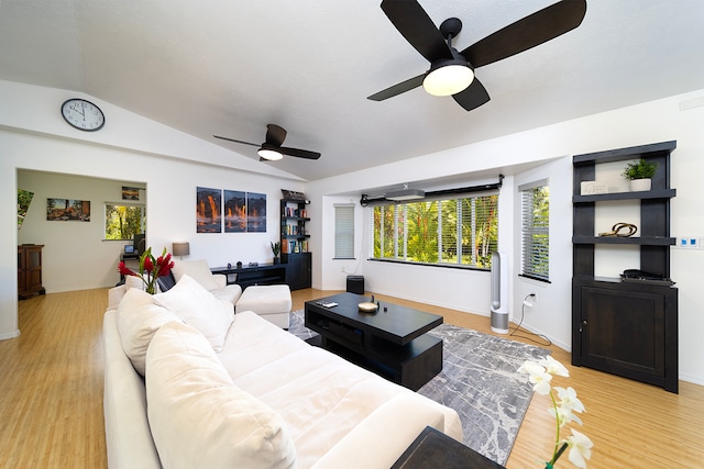 living room featuring light wood-type flooring, vaulted ceiling, and ceiling fan