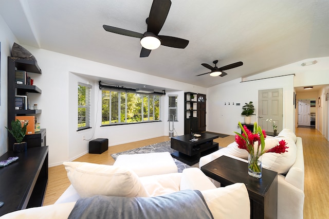 living room with light hardwood / wood-style floors, vaulted ceiling, and ceiling fan