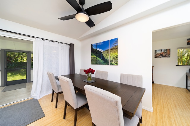 dining space with light hardwood / wood-style floors, a healthy amount of sunlight, lofted ceiling, and ceiling fan