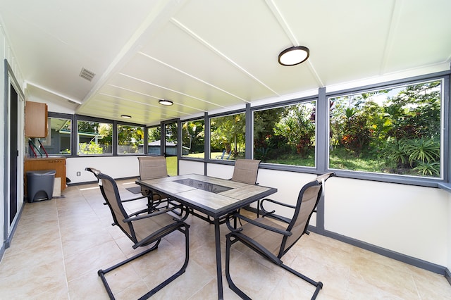 sunroom with a wealth of natural light and vaulted ceiling