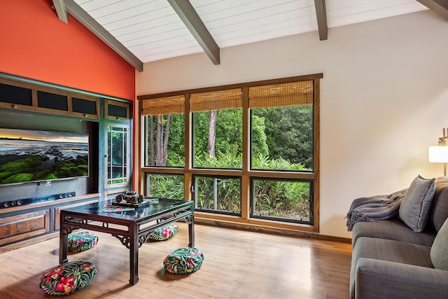 living room featuring beamed ceiling, light hardwood / wood-style floors, and high vaulted ceiling