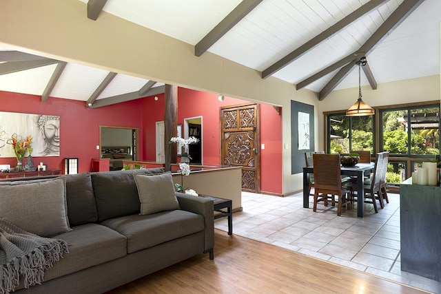 living room with lofted ceiling with beams and light hardwood / wood-style floors