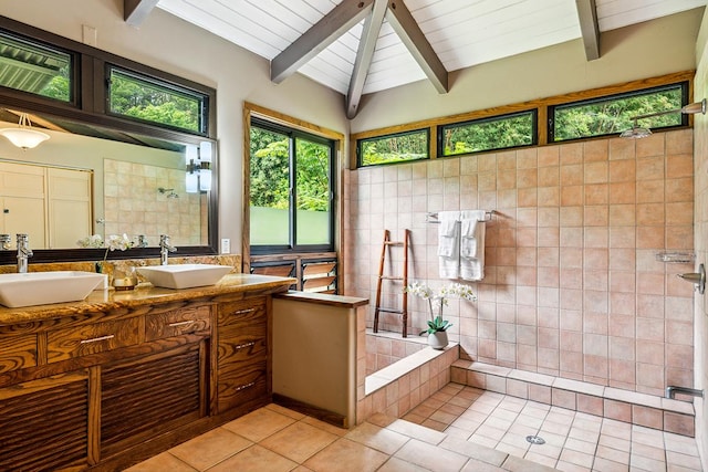 bathroom featuring tile patterned flooring, vanity, lofted ceiling with beams, and tile walls