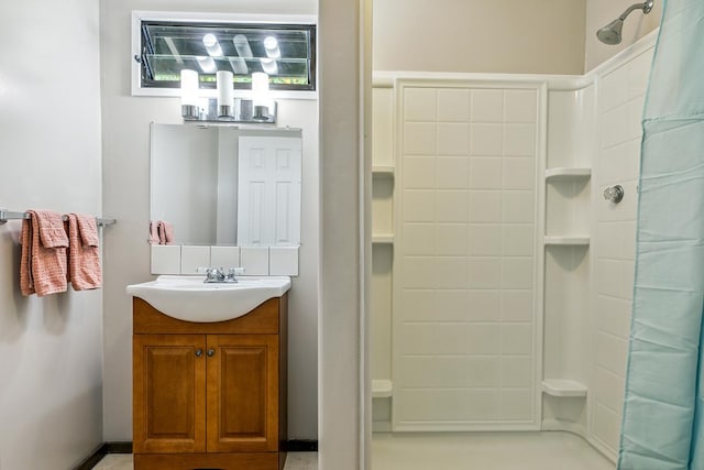 bathroom featuring vanity and curtained shower