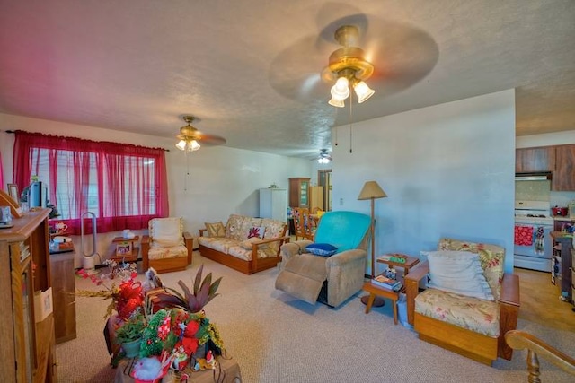 carpeted living room with ceiling fan