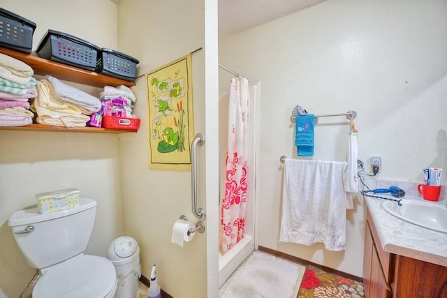 bathroom with vanity, toilet, and walk in shower