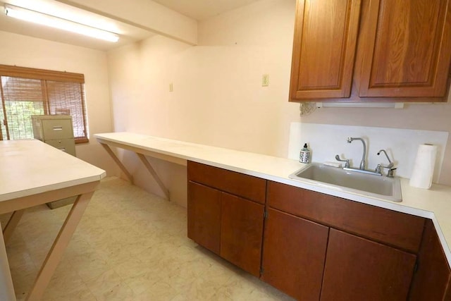 kitchen with sink and light tile floors