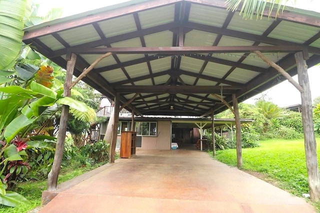 view of car parking with a carport and a lawn