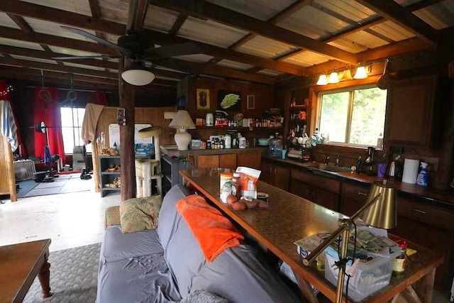 interior space with beamed ceiling, sink, ceiling fan, and a wealth of natural light