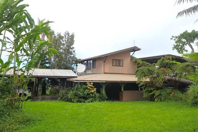 rear view of property with a lawn