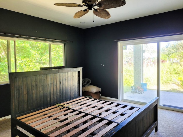 bedroom featuring ceiling fan, access to exterior, and light carpet