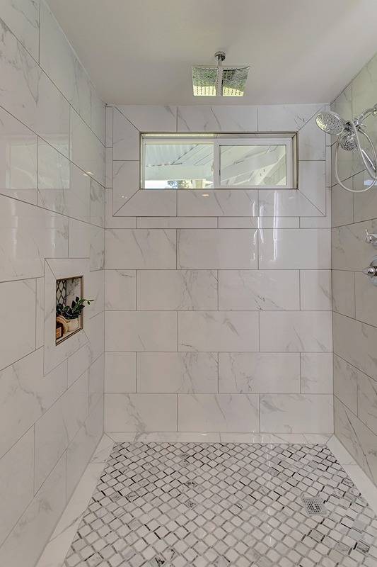 bathroom with tiled shower