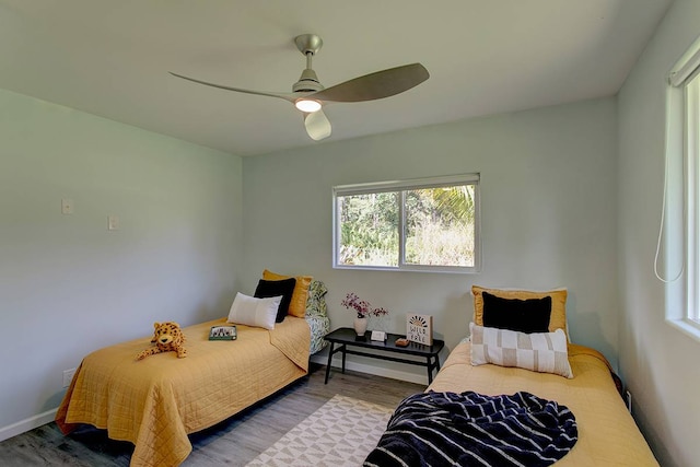 bedroom with ceiling fan and hardwood / wood-style flooring