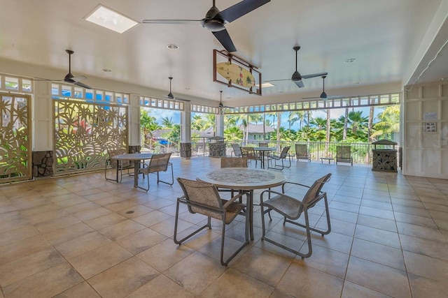 interior space with light tile flooring and ceiling fan