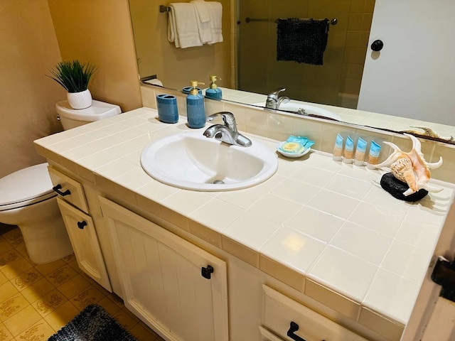 bathroom featuring tile floors, toilet, and vanity