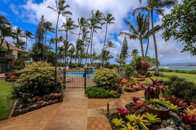 view of home's community featuring a water view and a pool