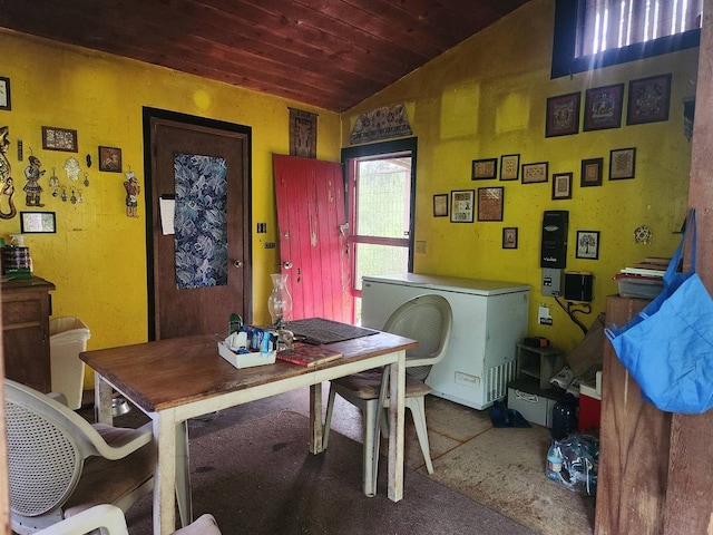 dining room with carpet floors, wood ceiling, and lofted ceiling