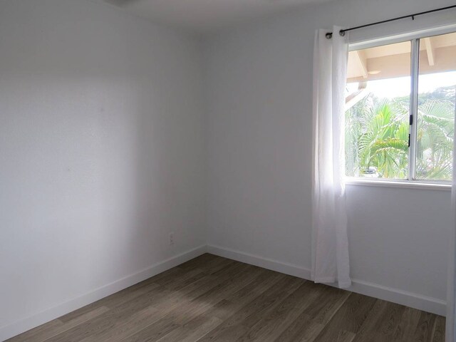 spare room with dark wood-type flooring