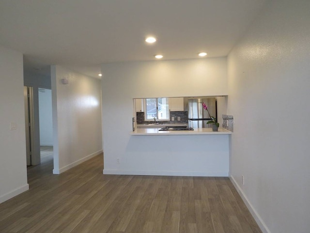 kitchen with backsplash and hardwood / wood-style flooring