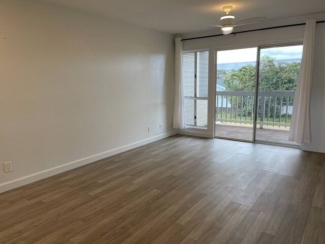 empty room featuring dark hardwood / wood-style floors and ceiling fan