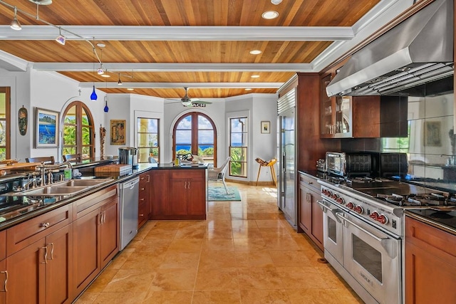 kitchen featuring a wealth of natural light, wooden ceiling, appliances with stainless steel finishes, and wall chimney range hood