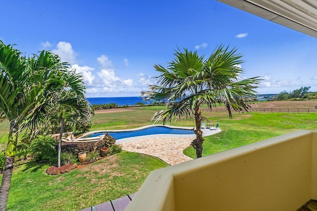 view of pool featuring a water view and a yard