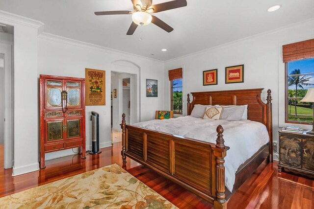 bedroom with dark hardwood / wood-style flooring, ceiling fan, and multiple windows