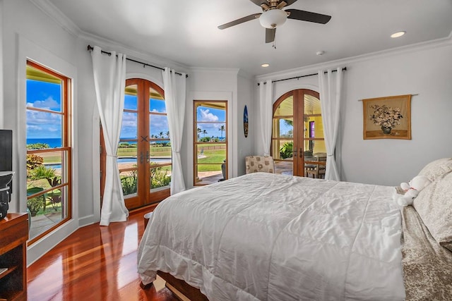 bedroom featuring french doors, ceiling fan, access to outside, dark wood-type flooring, and a water view