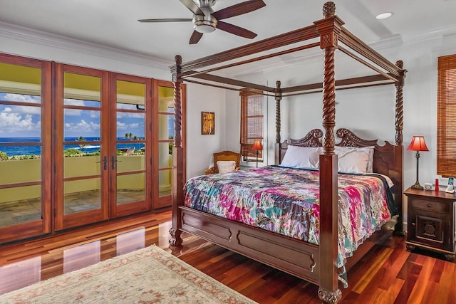 bedroom featuring dark hardwood / wood-style flooring, french doors, a water view, ceiling fan, and access to outside