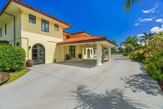 view of front of property with a patio and french doors