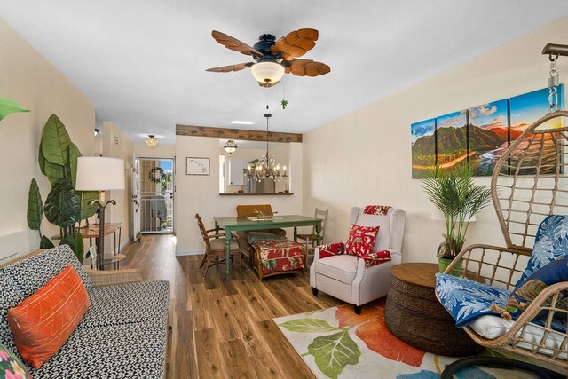 living room featuring hardwood / wood-style floors and ceiling fan with notable chandelier