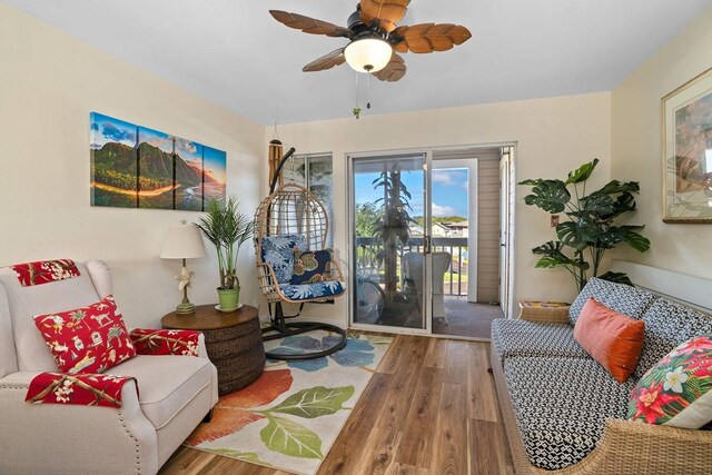 sitting room with ceiling fan and light wood-type flooring