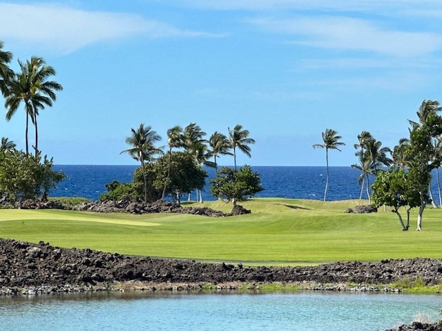 surrounding community with a water view and a lawn