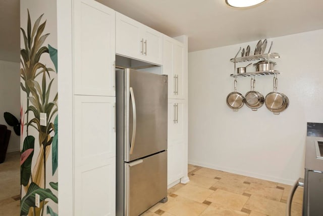 kitchen with light tile floors, white cabinetry, and stainless steel fridge